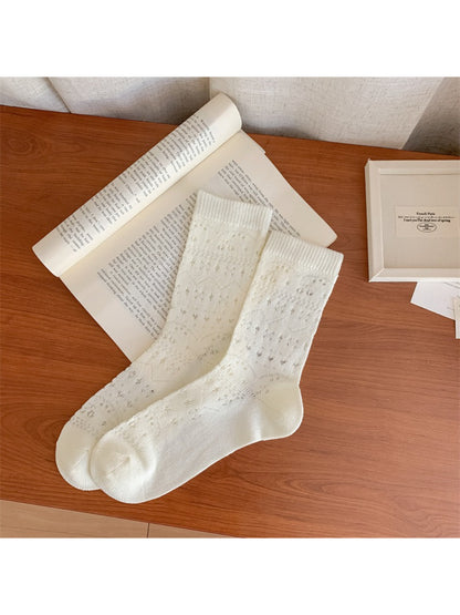 Rufia dainty cherry socks folded neatly to display knit texture and cherry design