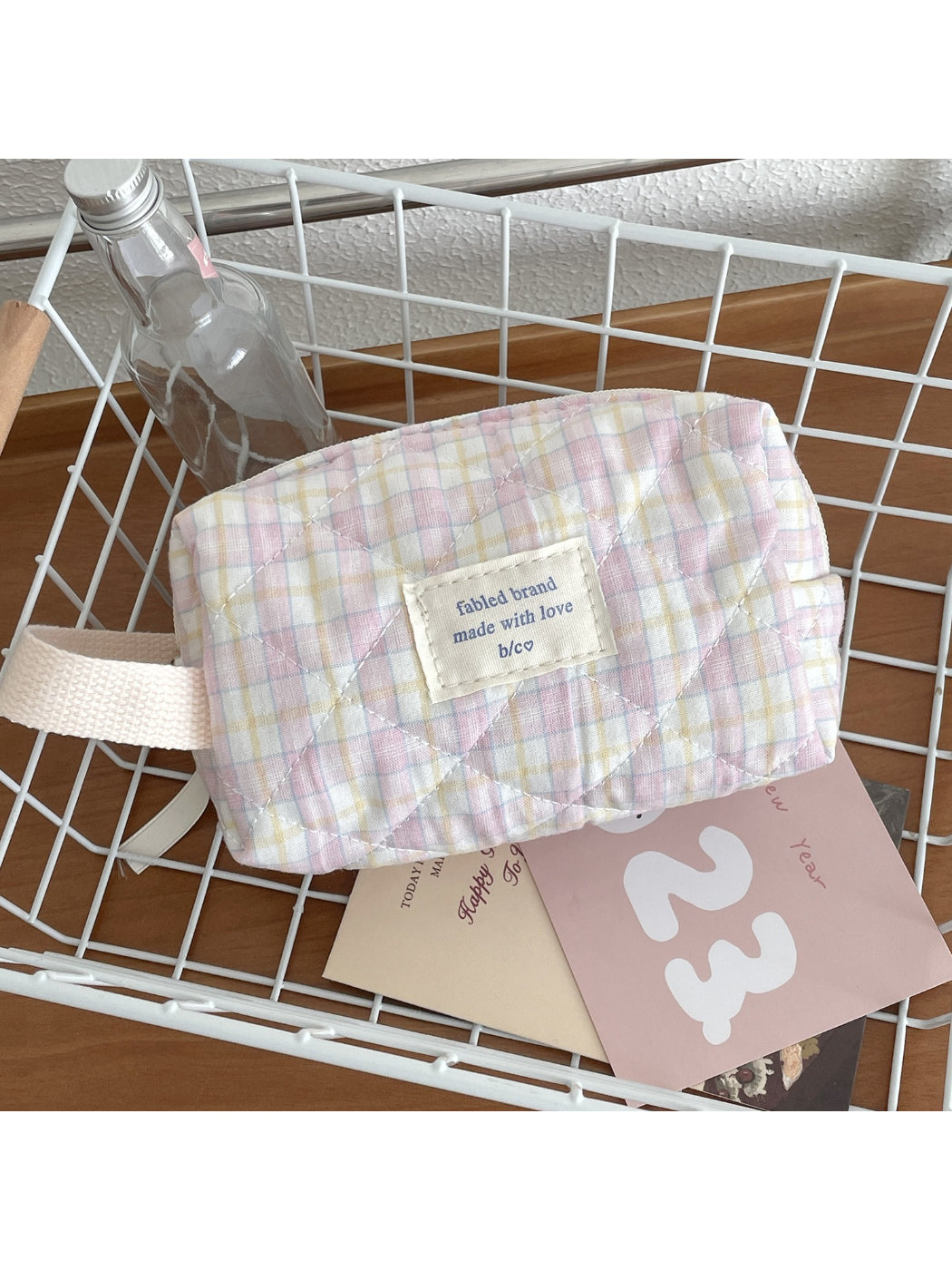Open Cosbai travel makeup bag showing spacious interior with pastel check design