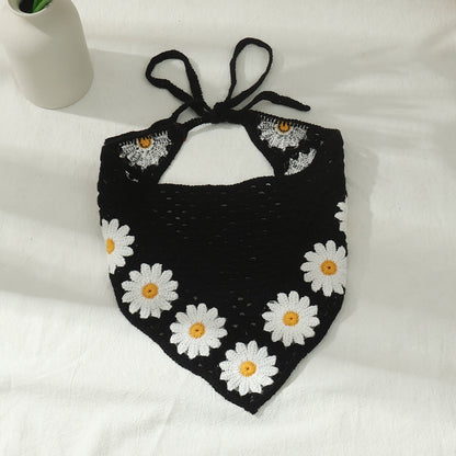 Crochet hairband displayed on white background highlighting sunflower and mushroom