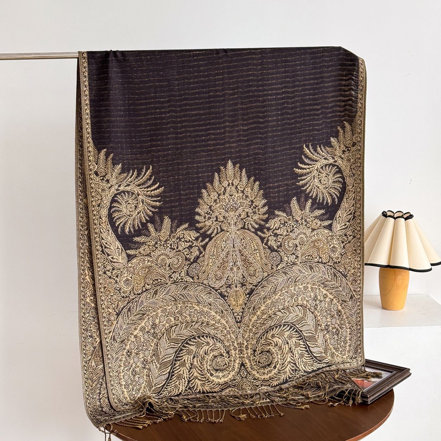 Scarvii paisley scarf draped over wooden hanger