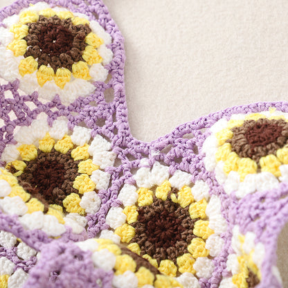 Cosbai Bohemian Sunflower Crochet Bag with strap looped on a plain surface