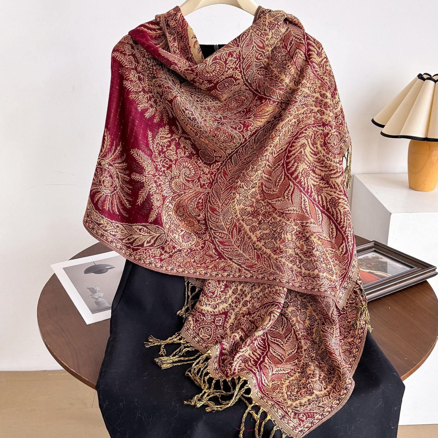 Ornate paisley tassel scarf folded on white background