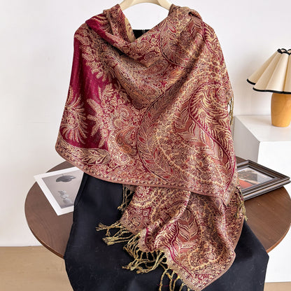 Ornate paisley tassel scarf folded on white background