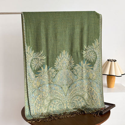 Close-up of intricate paisley pattern on scarf with tassels