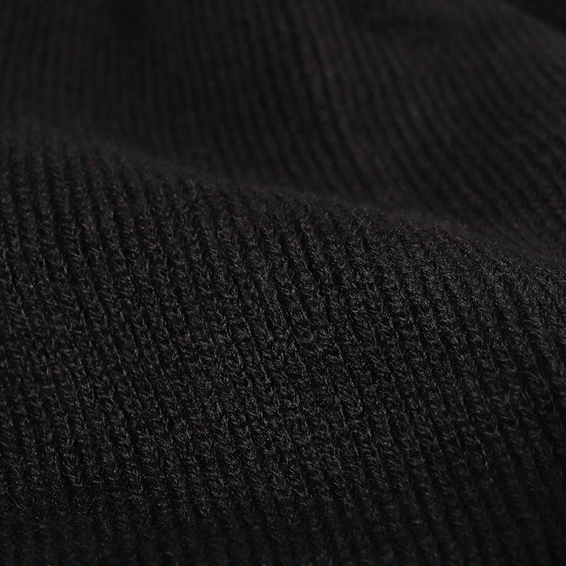 Black plush lined pom cuffed knit beanie detail