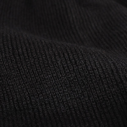 Black plush lined pom cuffed knit beanie detail