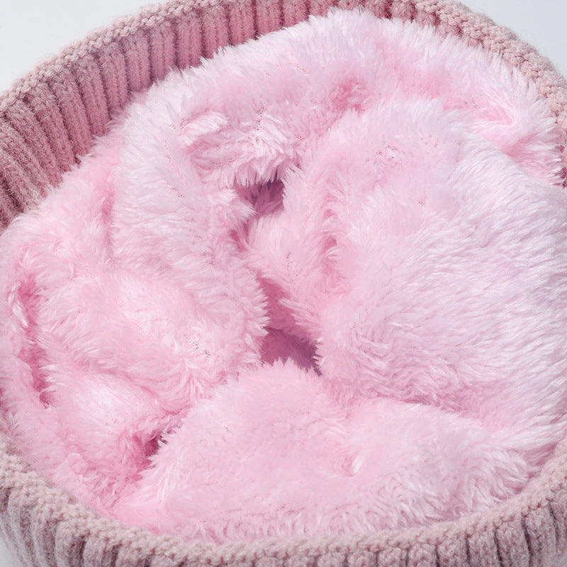 Pink plush lined cable knit pom beanie detail