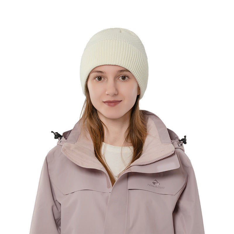 Ivory ribbed cuff knit beanie front view on a model
