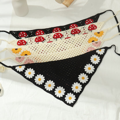 Top view of crochet hairband showing arrangement of sunflower and mushroom
