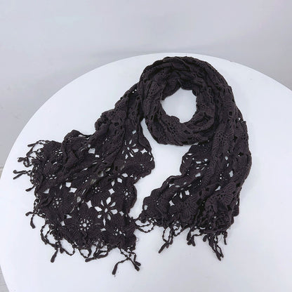 Detailed view of crochet stitches on cream boho shawl scarf