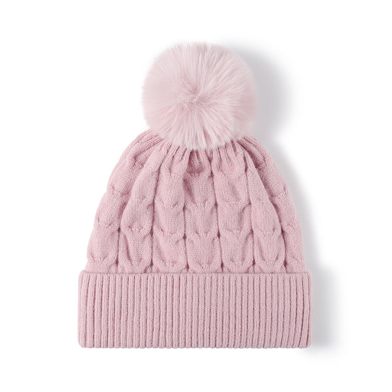 Pink plush lined cable knit pom beanie detail