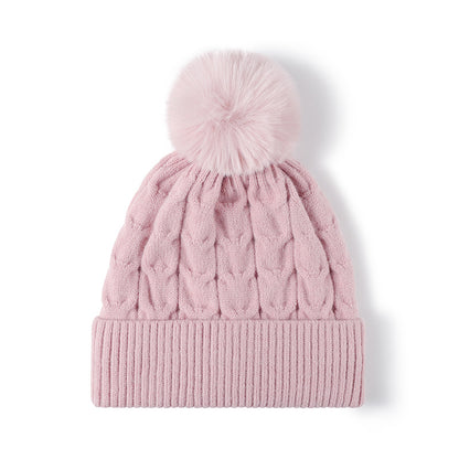 Pink plush lined cable knit pom beanie detail