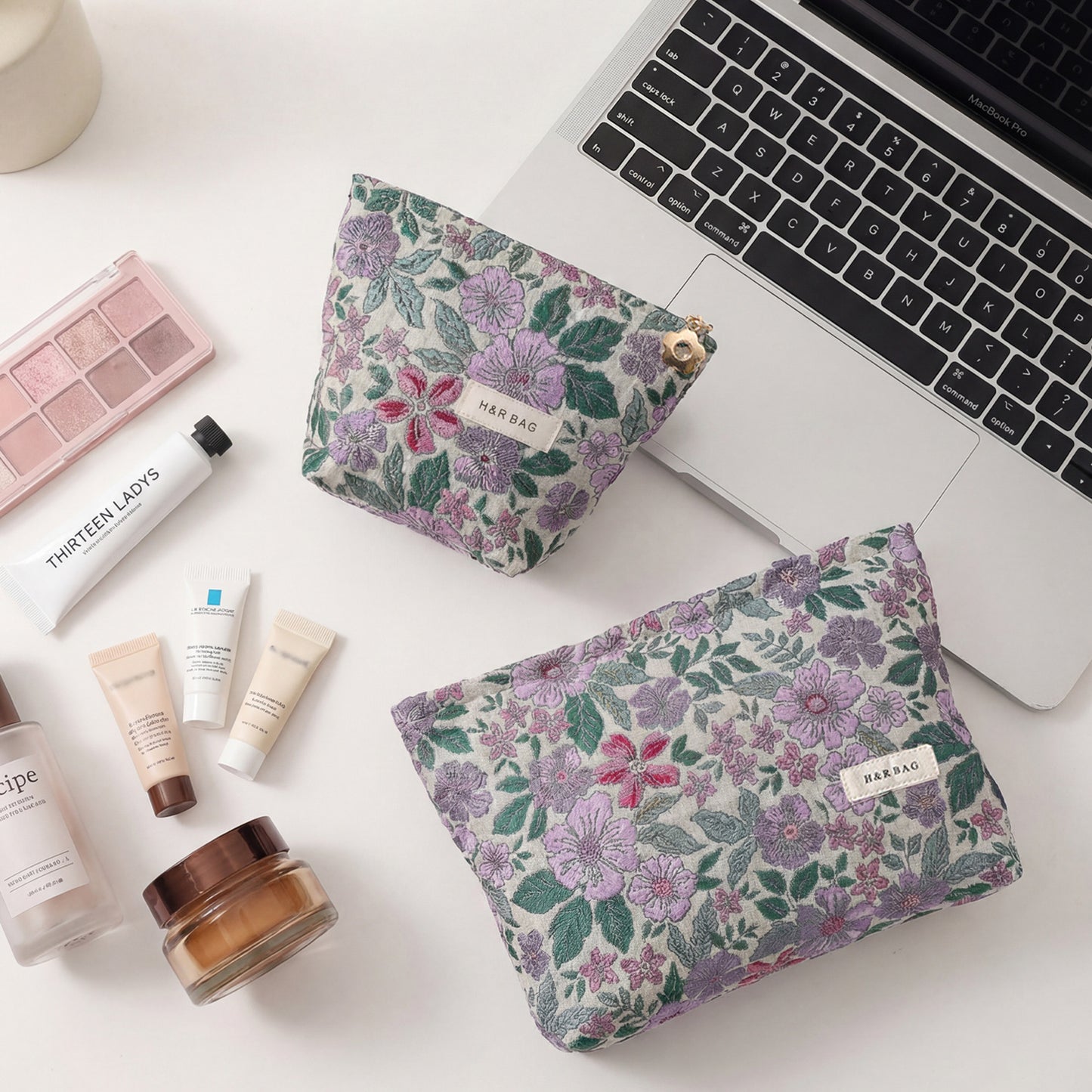 Cosbai cosmetic bag with textured flower design and chain strap displayed on flat surface