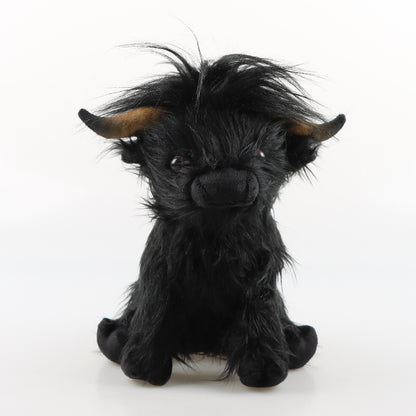 Black and white cow plush toy side view