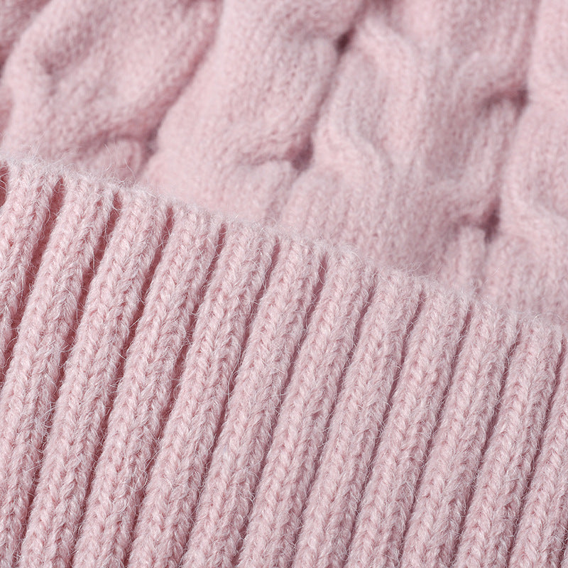 Pink plush lined cable knit pom beanie detail