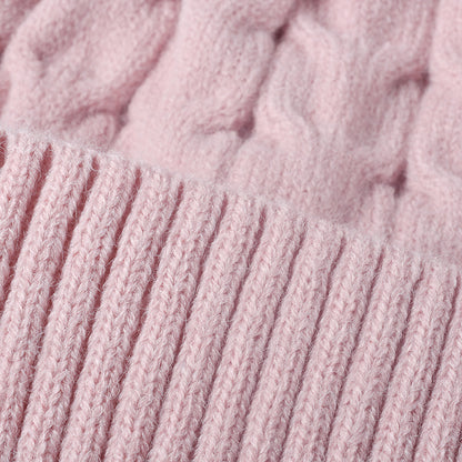 Pink plush lined cable knit pom beanie detail