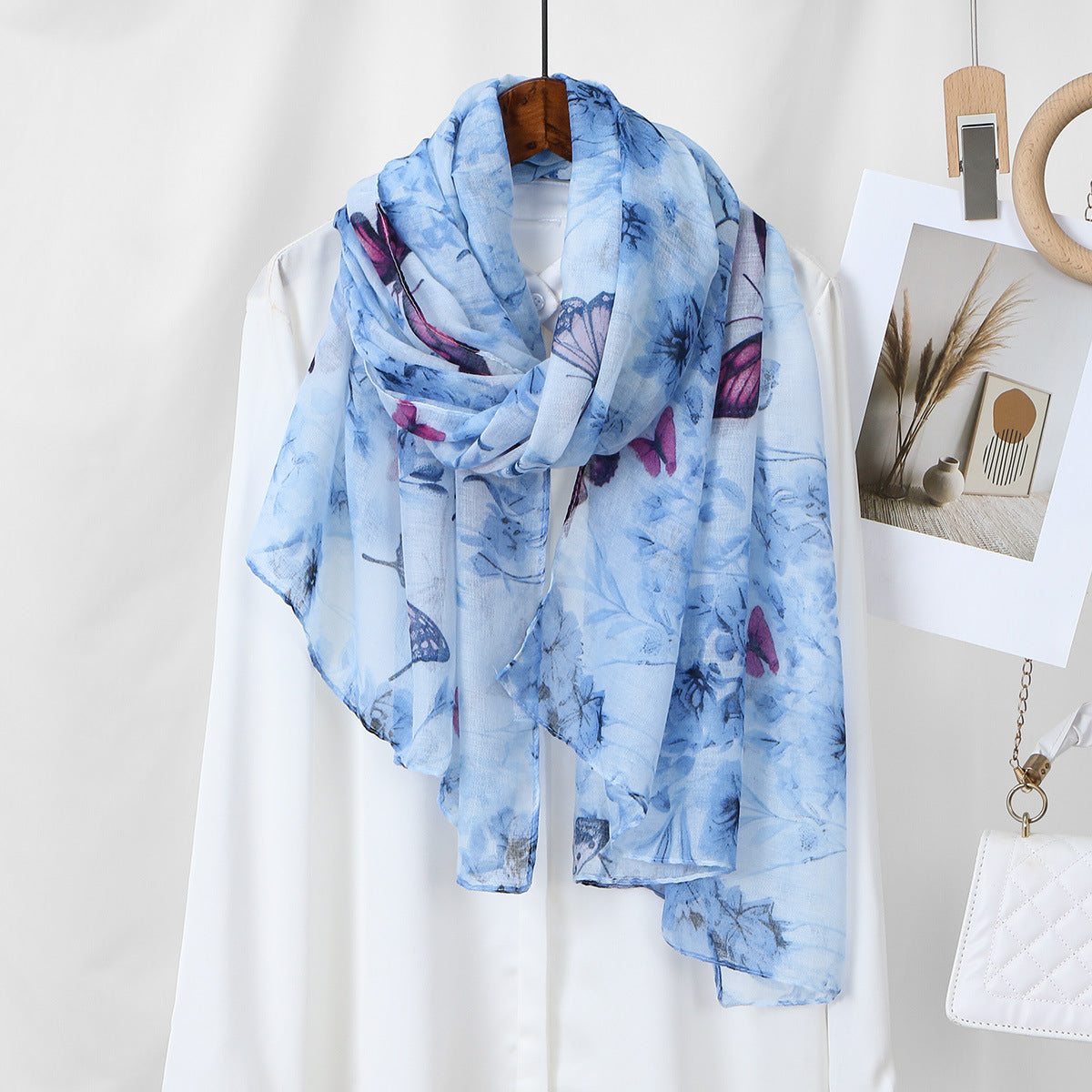 Scarvii lightweight scarf displayed with matching botanical butterfly accessories