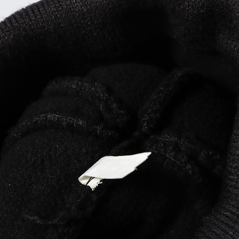 Black plush lined pom cuffed knit beanie detail