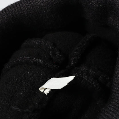 Black plush lined pom cuffed knit beanie detail