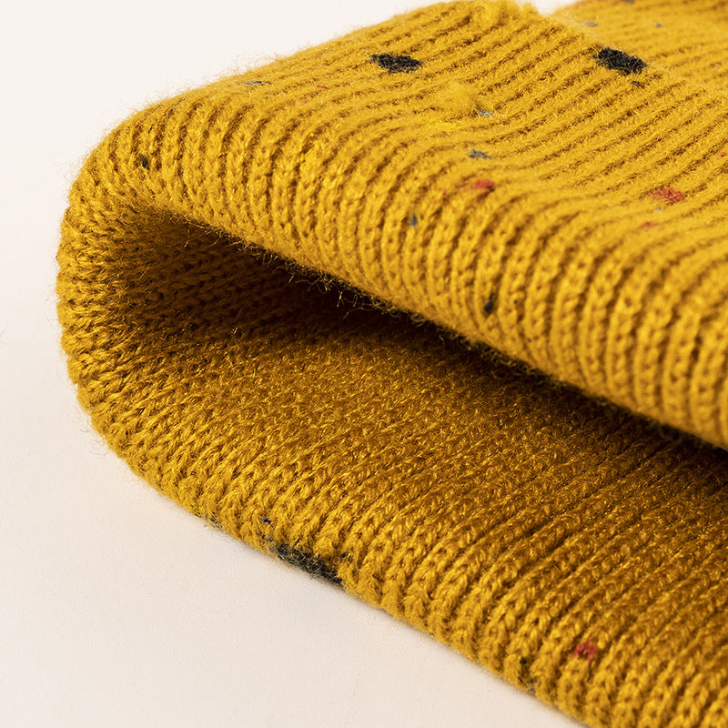 Yellow paint splatter cuffed knit beanie detail