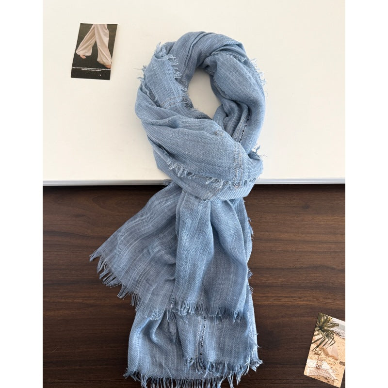 Light blue long scarf with fringed edges and openwork stripe details.