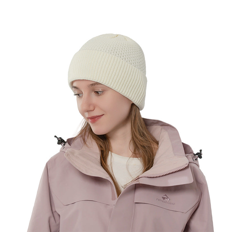 Ivory ribbed cuff knit beanie side view on a model