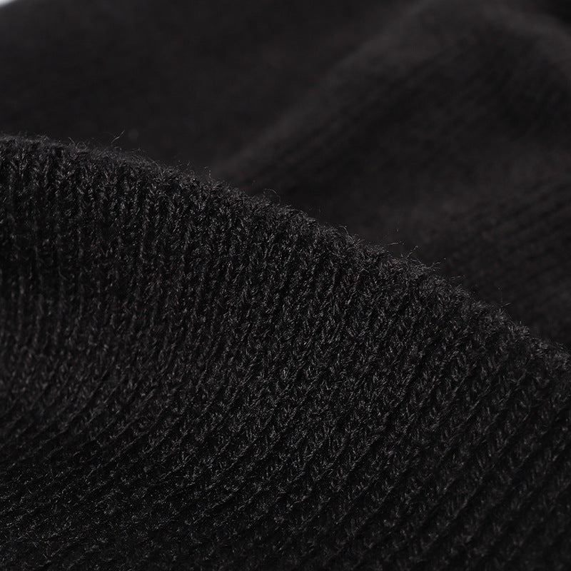 Black plush lined pom cuffed knit beanie detail