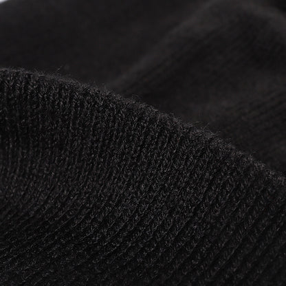 Black plush lined pom cuffed knit beanie detail