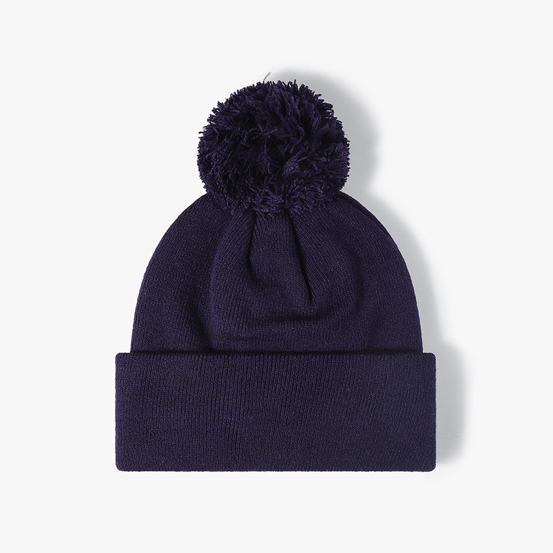 Navy plush lined pom cuffed knit beanie product view