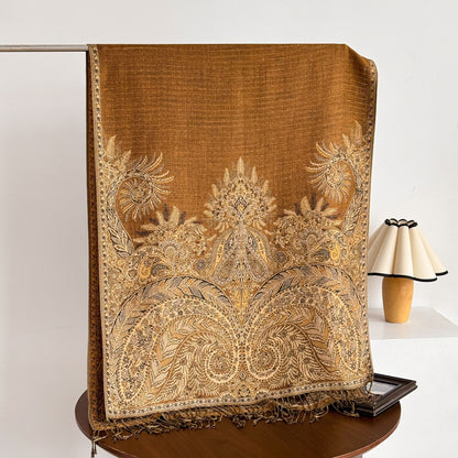 Scarvii scarf folded with tassels spread out on wooden surface