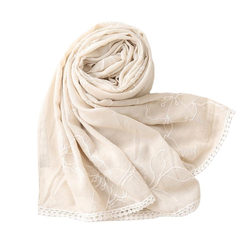 Beige floral embroidered lace trim shawl in a folded detail view
