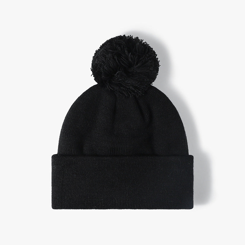 Black plush lined pom cuffed knit beanie product view