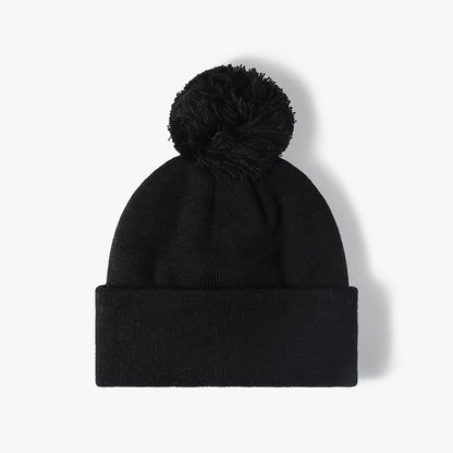 Black plush lined pom cuffed knit beanie product view