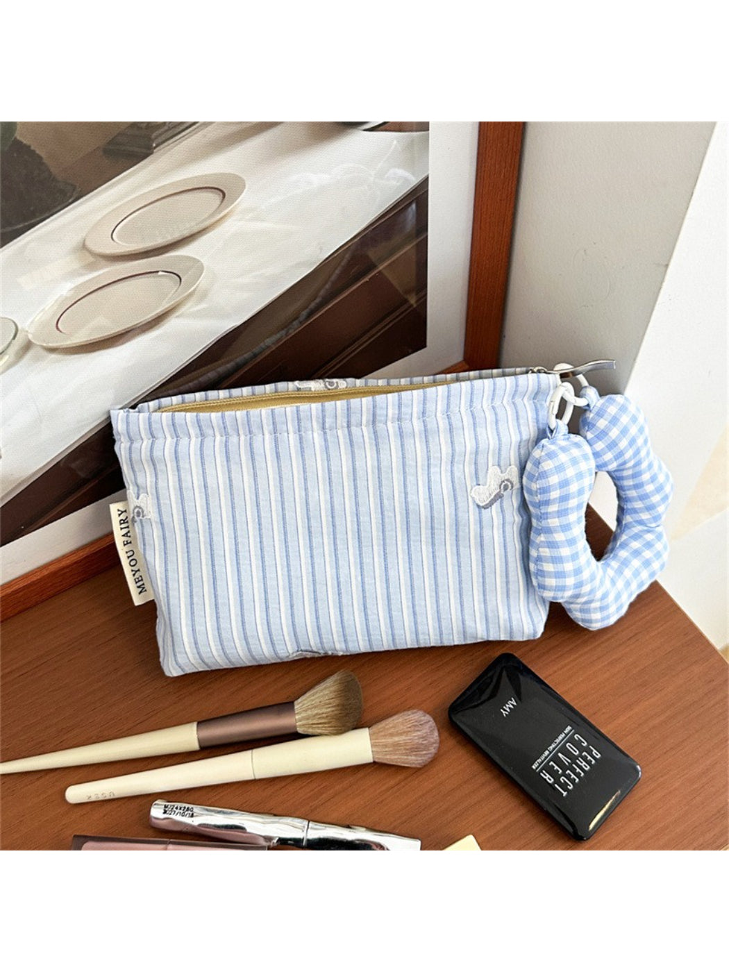 Side view of striped cosmetic bag highlighting fabric texture