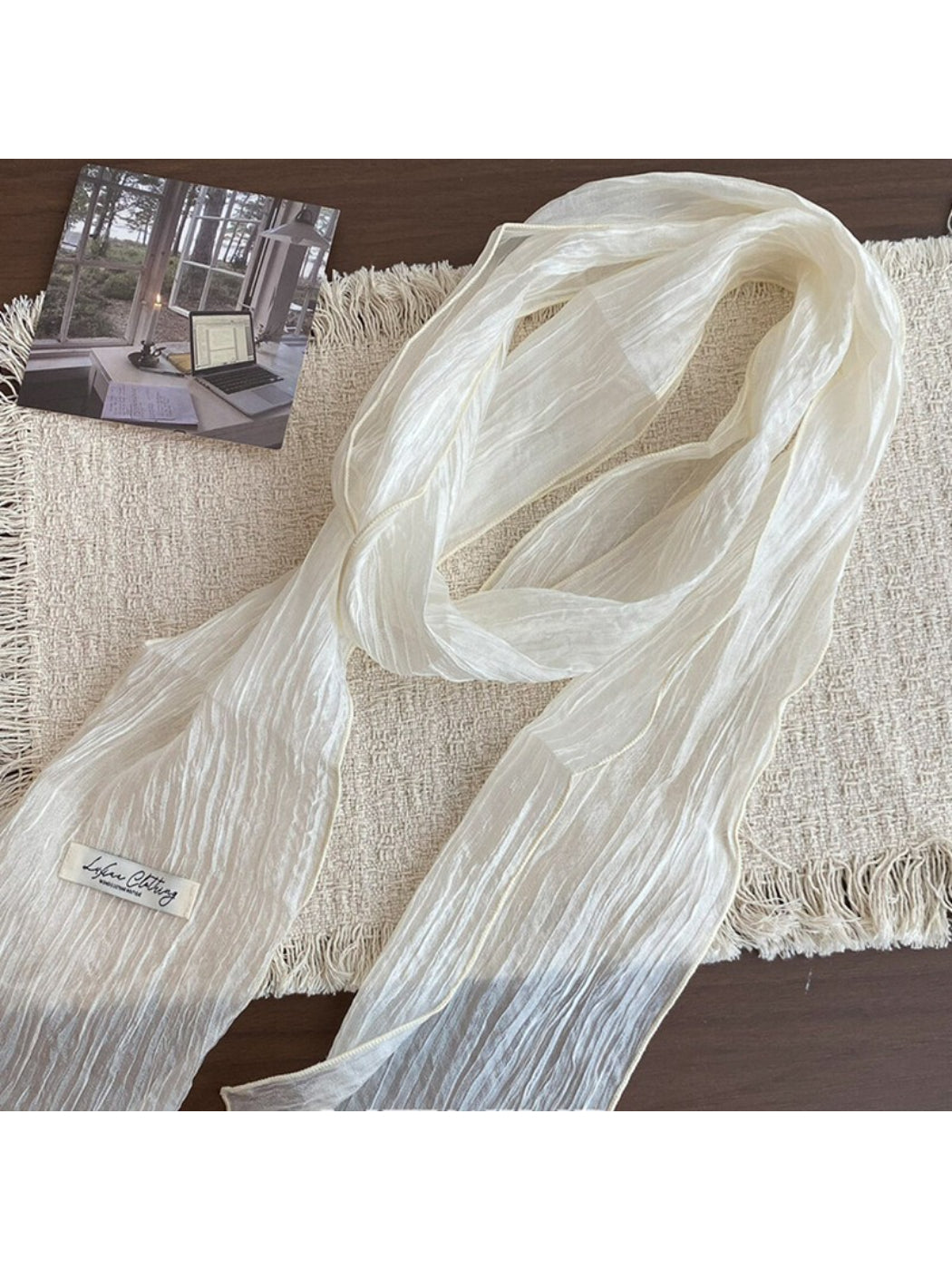 Lightweight pleated neck scarf in soft pastel pink fabric draped on a mannequin