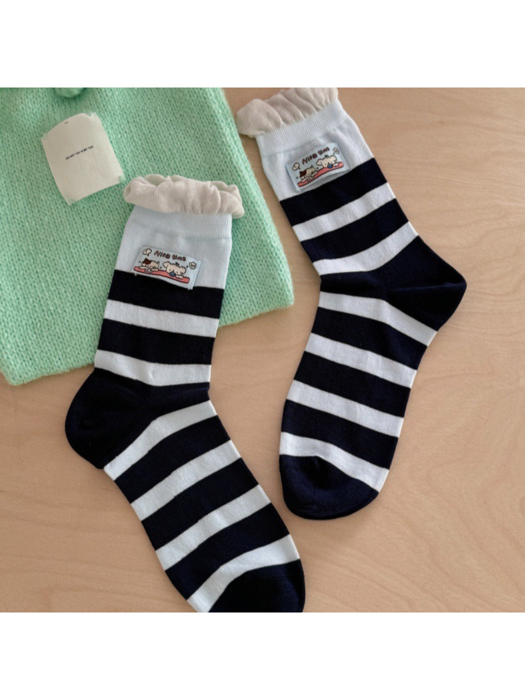 Side view of Rufia pastel pink ribbed socks highlighting patch embroidery