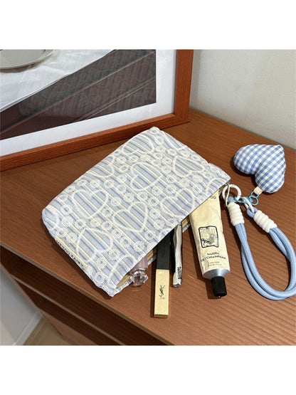 Cosbai cosmetic pouch placed on a vanity table with makeup items around