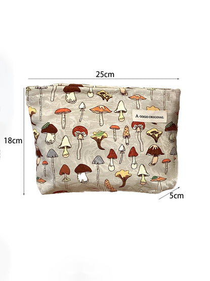 Cosbai cosmetic bag placed on wooden surface highlighting forest mushroom design