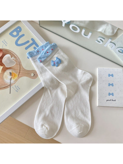 Model wearing Rufia Sweet Blue Ribbon crew socks paired with casual shoes