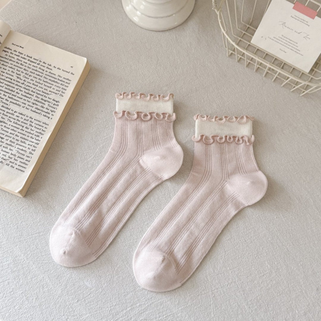 Pair of pastel pink Rufia Sweet Ruffle Edge Crew Socks displayed on white background
