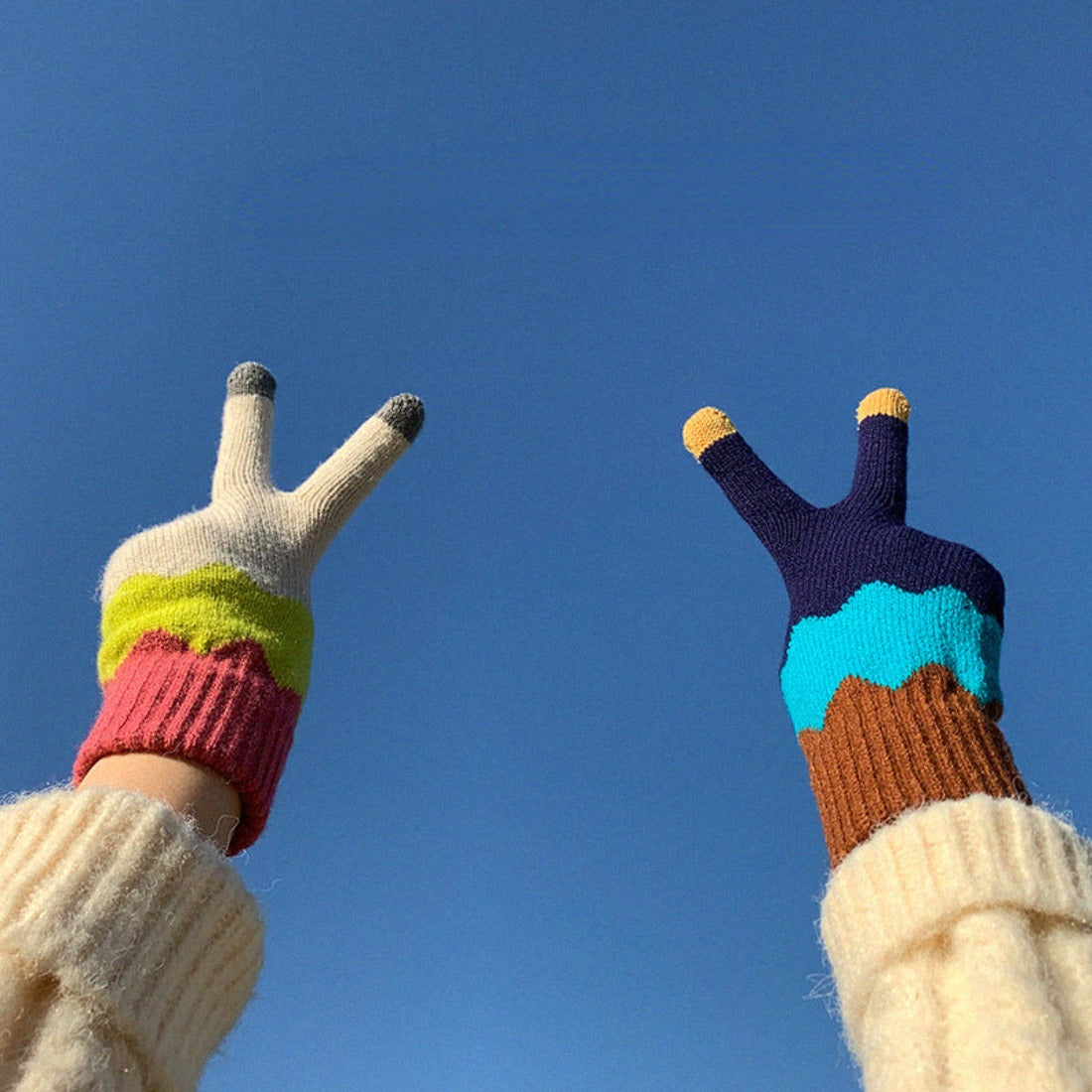 Close-up of fingertips on knitting patchwork touchscreen gloves