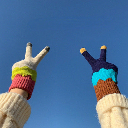 Close-up of fingertips on knitting patchwork touchscreen gloves