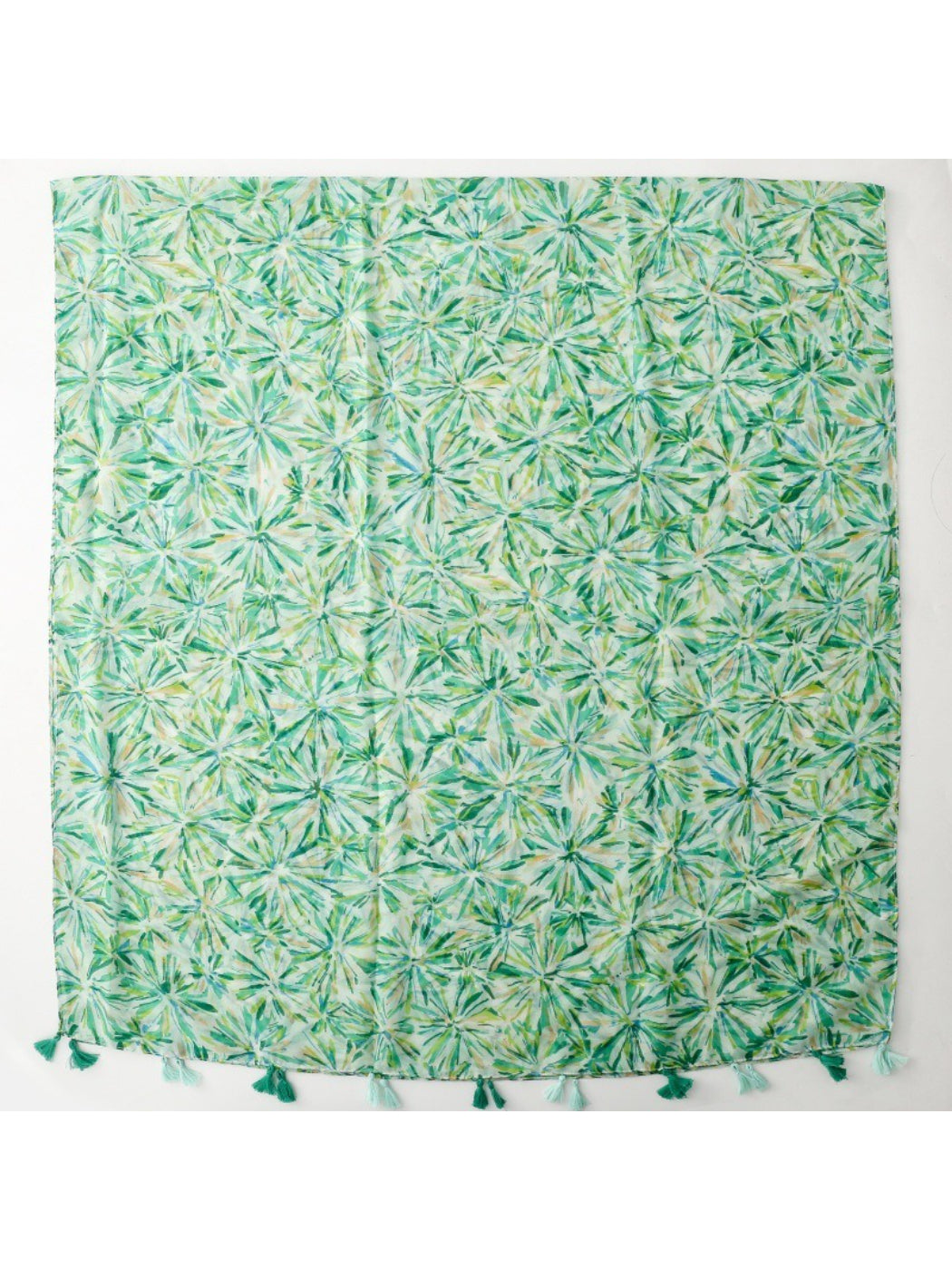 Model wearing green floral scarf with tassels around neck