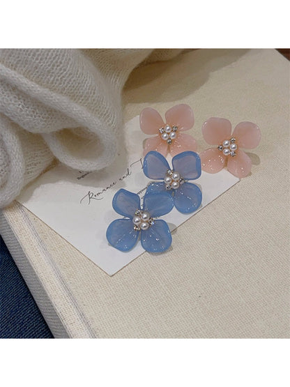 Pair of gold Rounded Petal Bloom Earrings with smooth rounded petals on a flat surface