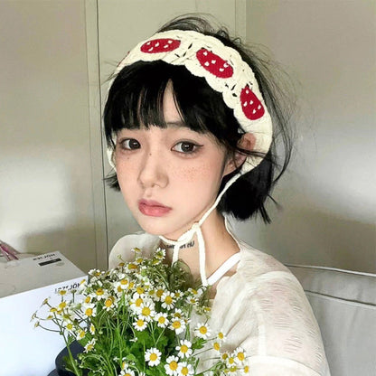Close-up of mushroom detail on Haila crochet hairband with red cap and white spots