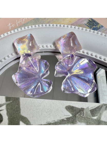 Close-up of Earwish purple flower drop earrings with silver hooks on white background