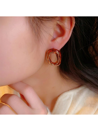 Close-up of Earwish sculpted oval earrings showing smooth curved design