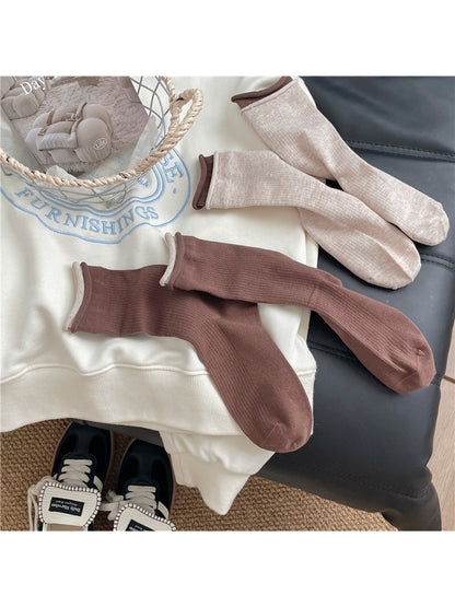 Stack of Rufia casual roll cuff crew socks showing different color options