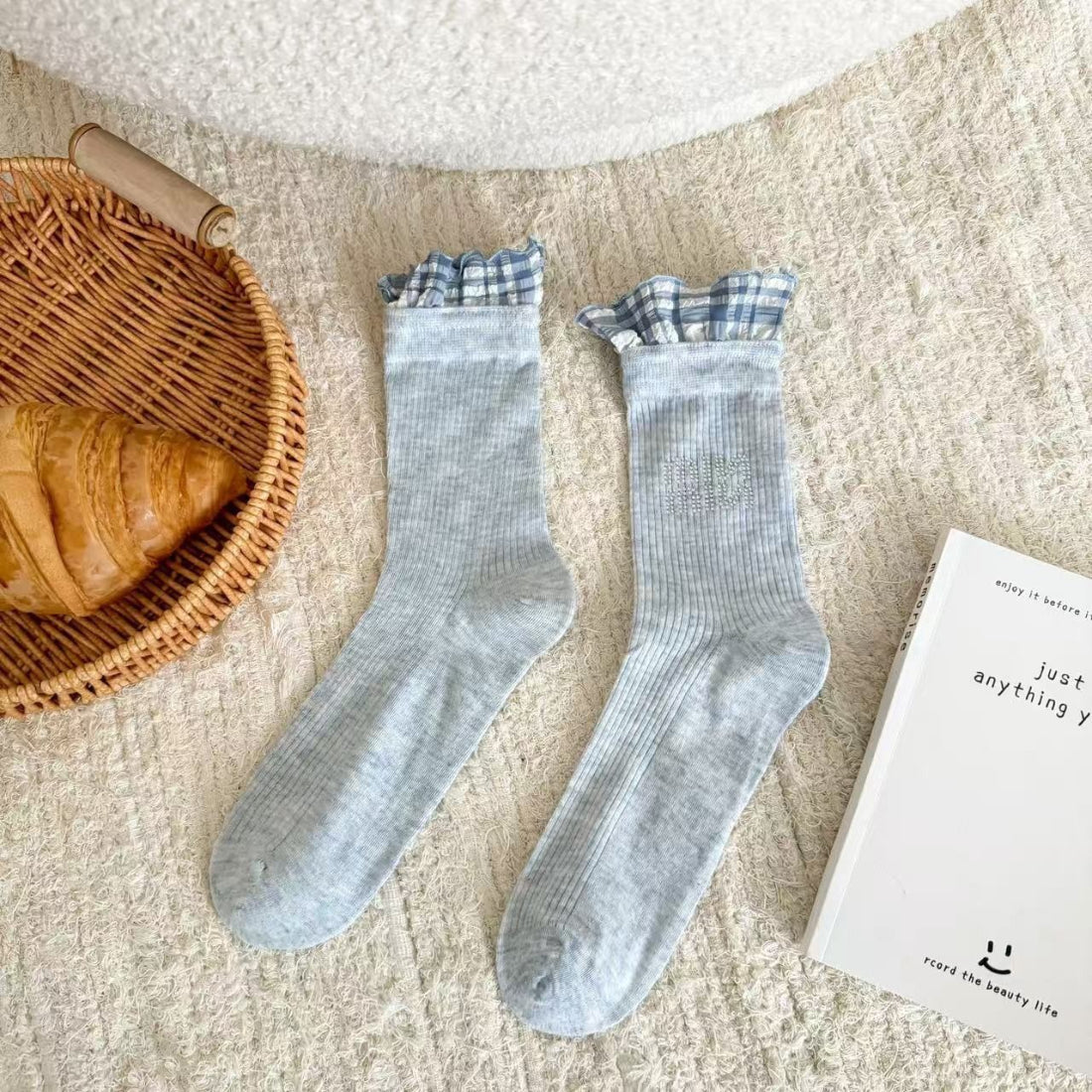 Model wearing Rufia ruffle pastel mid-calf socks paired with casual shoes