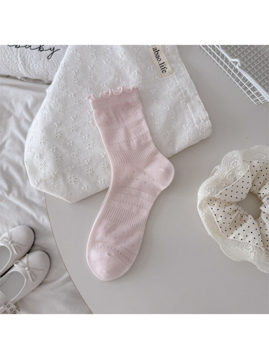 Rufia socks folded to show soft fabric and delicate pointelle design